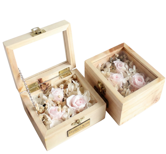 Two wooden boxes with preserved flowers on a white background