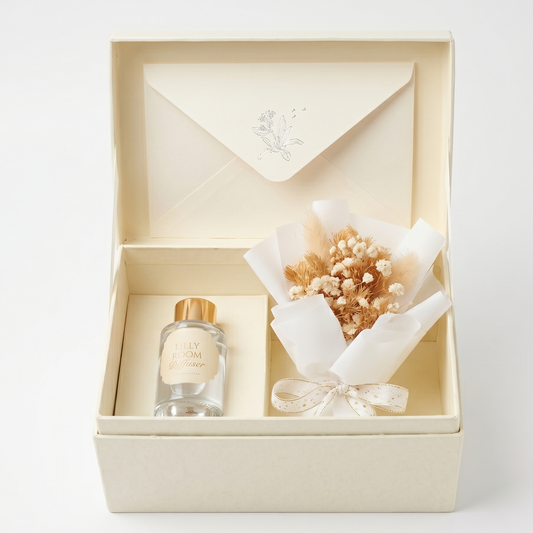 Gift set with a bottle and bouquet in an open box on a white background