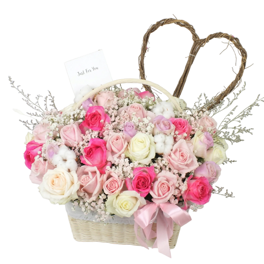 Floral arrangement in a basket with pink and white roses on a light background
