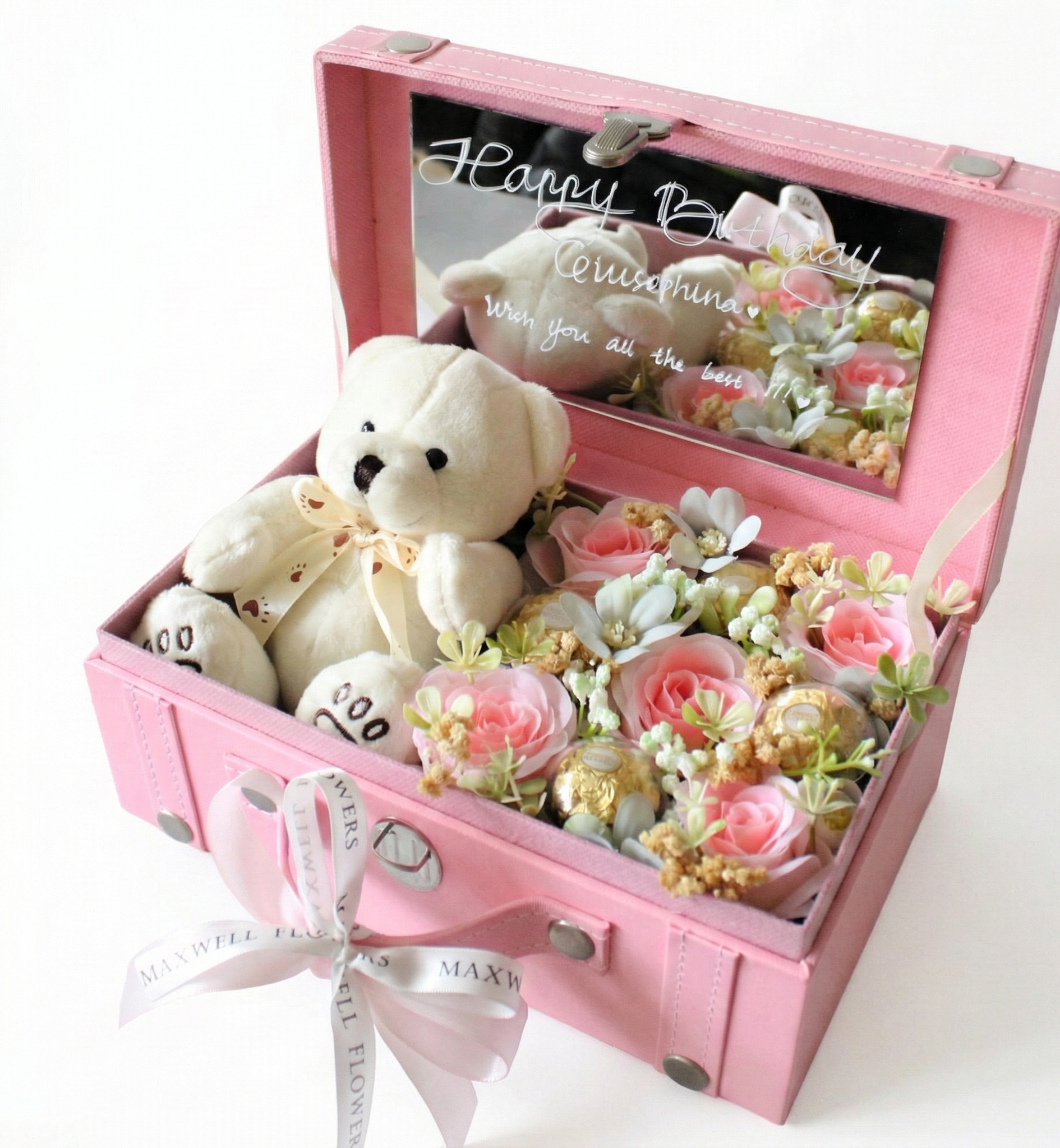 Pink gift box with a teddy bear and floral arrangement, featuring a 'Happy Birthday' message.