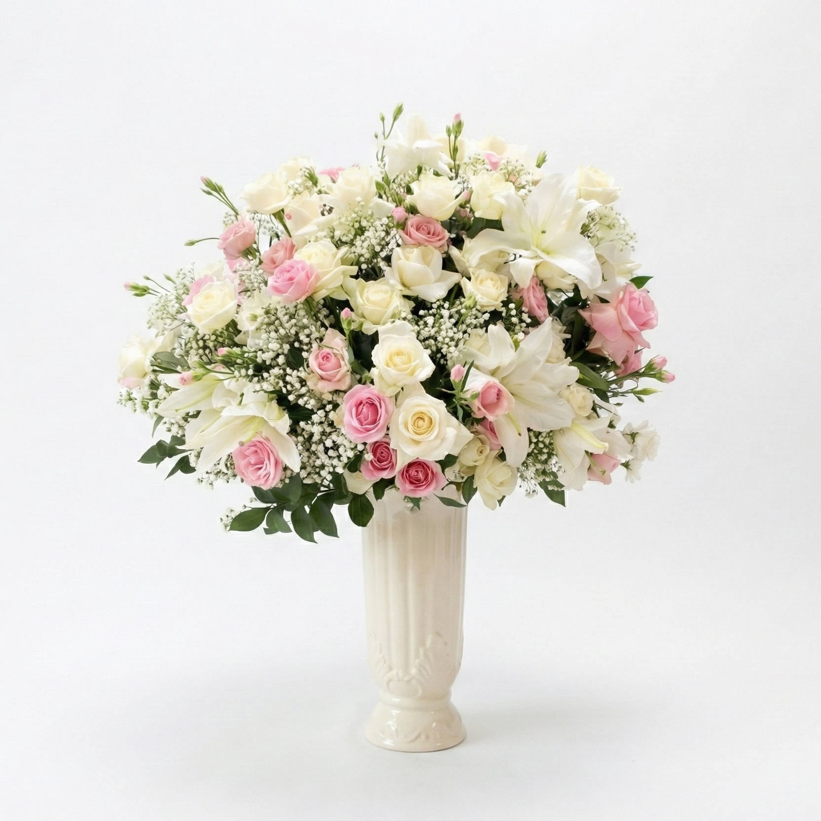 Bouquet of flowers in a white vase on a white background