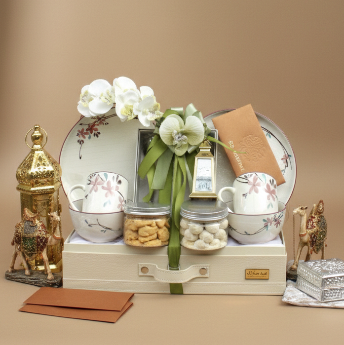 Decorative set with teapots, flowers, and small items on a beige background