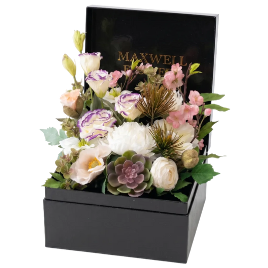 Floral arrangement in a black box with 'Maxwell & Williams' branding on a white background