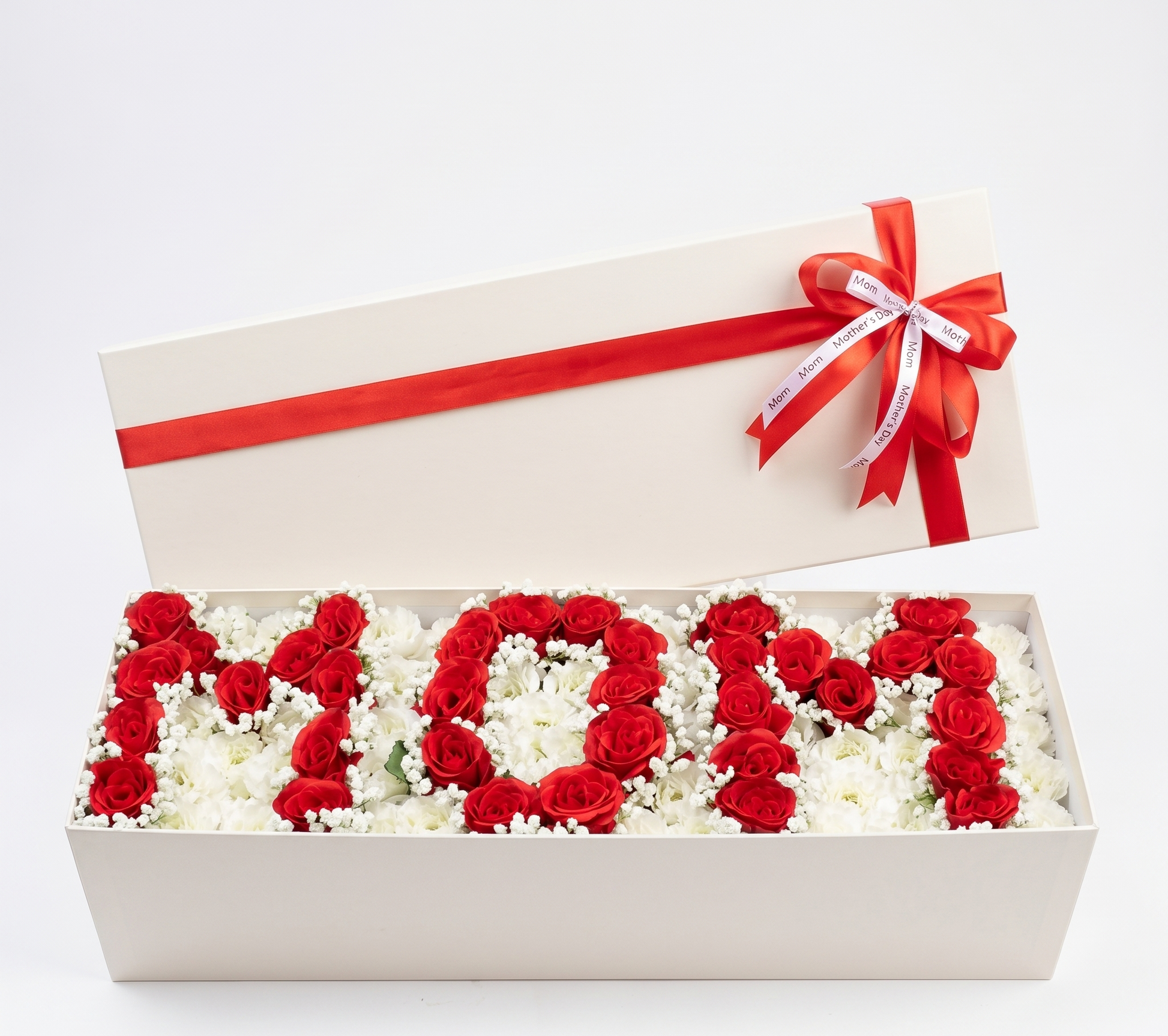 Floral arrangement spelling 'MOM' in a box with a red ribbon on a white background
