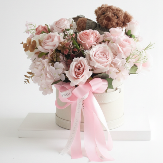 Bouquet of flowers with a teddy bear and pink ribbon on a white background